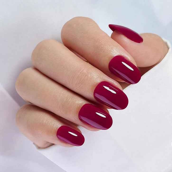 Glossy deep berry-red short oval soft gel press-on nails, solid high-shine finish